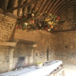 The great hall. I love the huge wreath of dried flowers and greenery over the table.