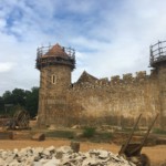 One tower almost complete and another under construction. The pile of stones in front is from the stonemason's workshop.