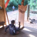 Tim playing a medieval game with ropes and balls.